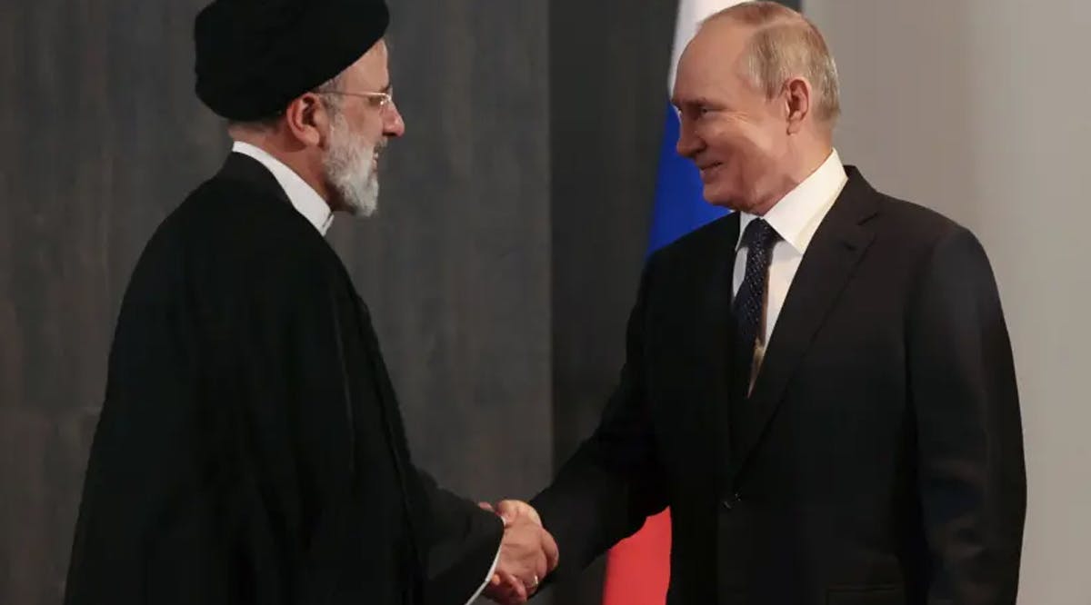 Russian President Vladimir Putin shakes hands with Iranian President Ebrahim Raisi