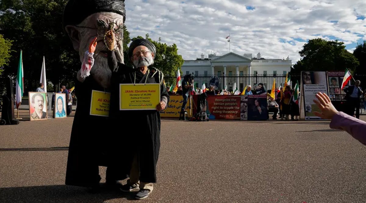 Iranian Americans, including two people dressed up as Iranian Supreme Leader Ayatollah Ali Khamenei and President Ebrahim Raisi, rally outside the White House