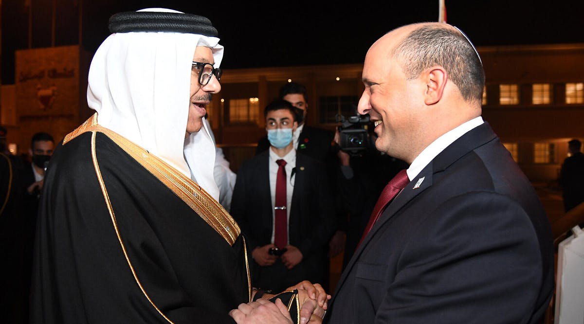 Prime Minister Naftali Bennett (R) is greeted by Bahrain's Foreign Minister Abdullatif bin Rashid Al-Zayani in the capital, Manama