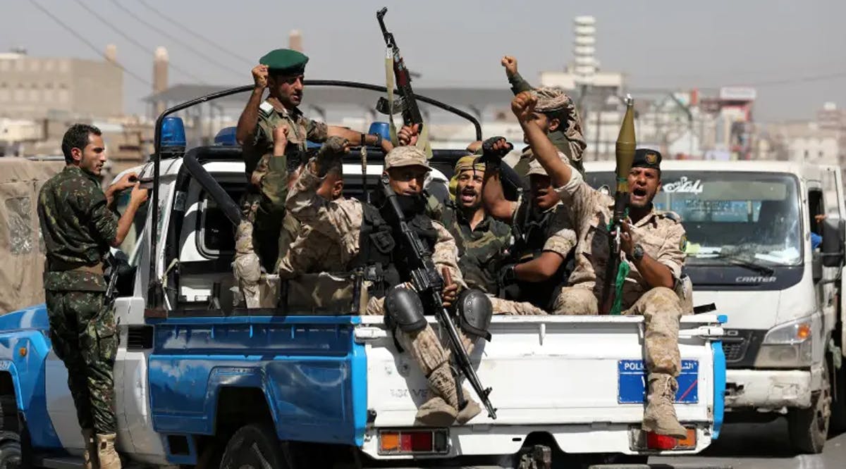 Houthi troops ride on the back of a police patrol truck after participating in a Houthi gathering in Sanaa, Yemen