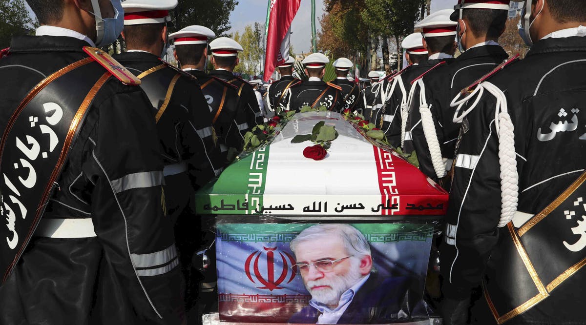 Military personnel stand near the flag-draped coffin of Mohsen Fakhrizadeh