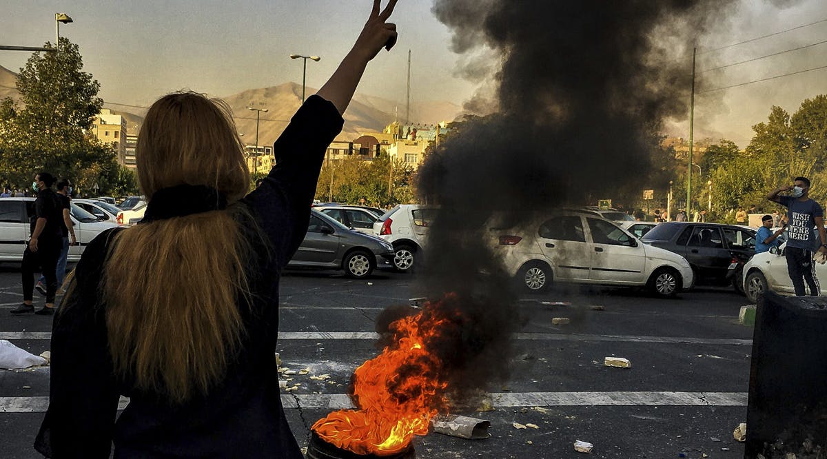 Iranians woman protests a 22-year-old woman Mahsa Amini's death after she was detained by the morality police, in Tehran