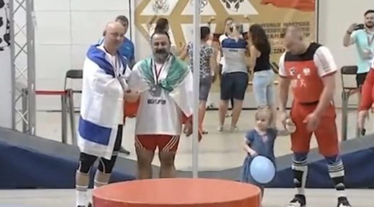 Mostafa Rajaei (R) shakes hands with Israeli weightlifter Maksim Svirsky at a World Masters championship in Wieliczka, Poland