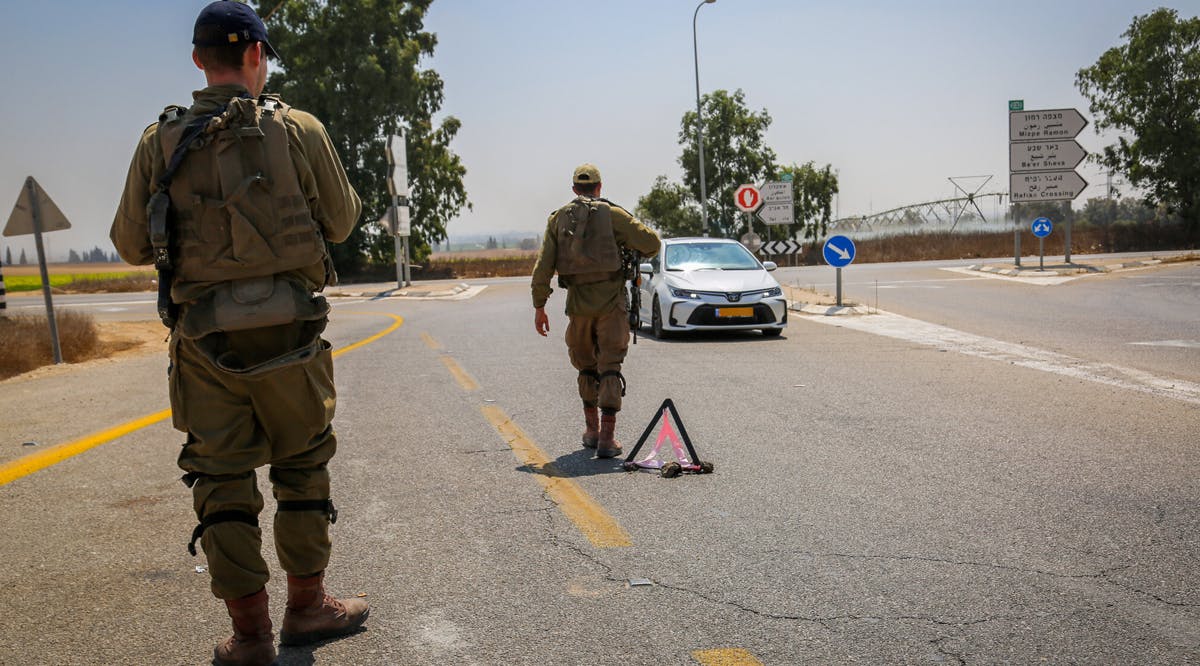 Israeli soldiers block roads near the border with the Gaza Strip