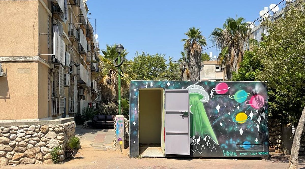 A painted mini-shelter outside of an apartment building in Ashkelon