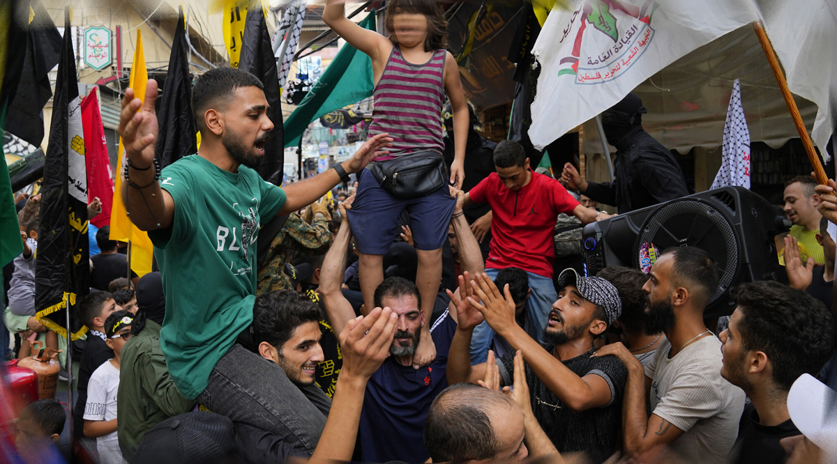 People dance in celebration of the attacks that the Hamas terror group carried out against Israel