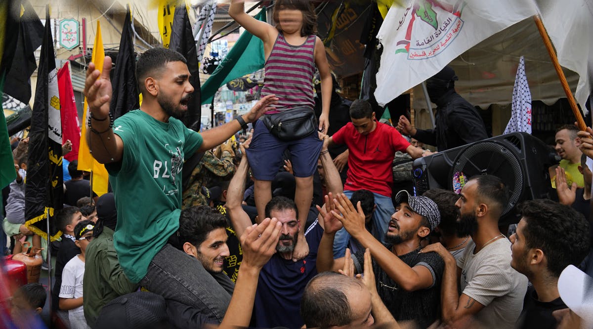 People dance in celebration of the attacks that the Hamas terror group carried out against Israel