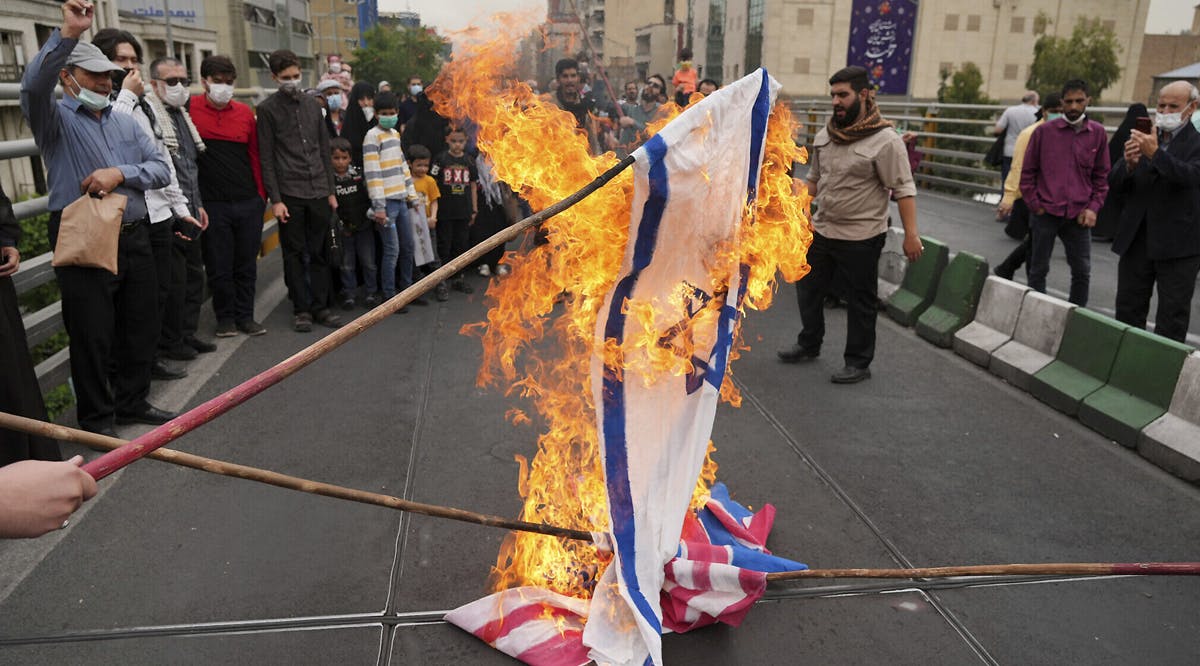 Iranians burn representations of Israeli, British and US flags during the annual al-Quds Day rally in Tehran, Iran