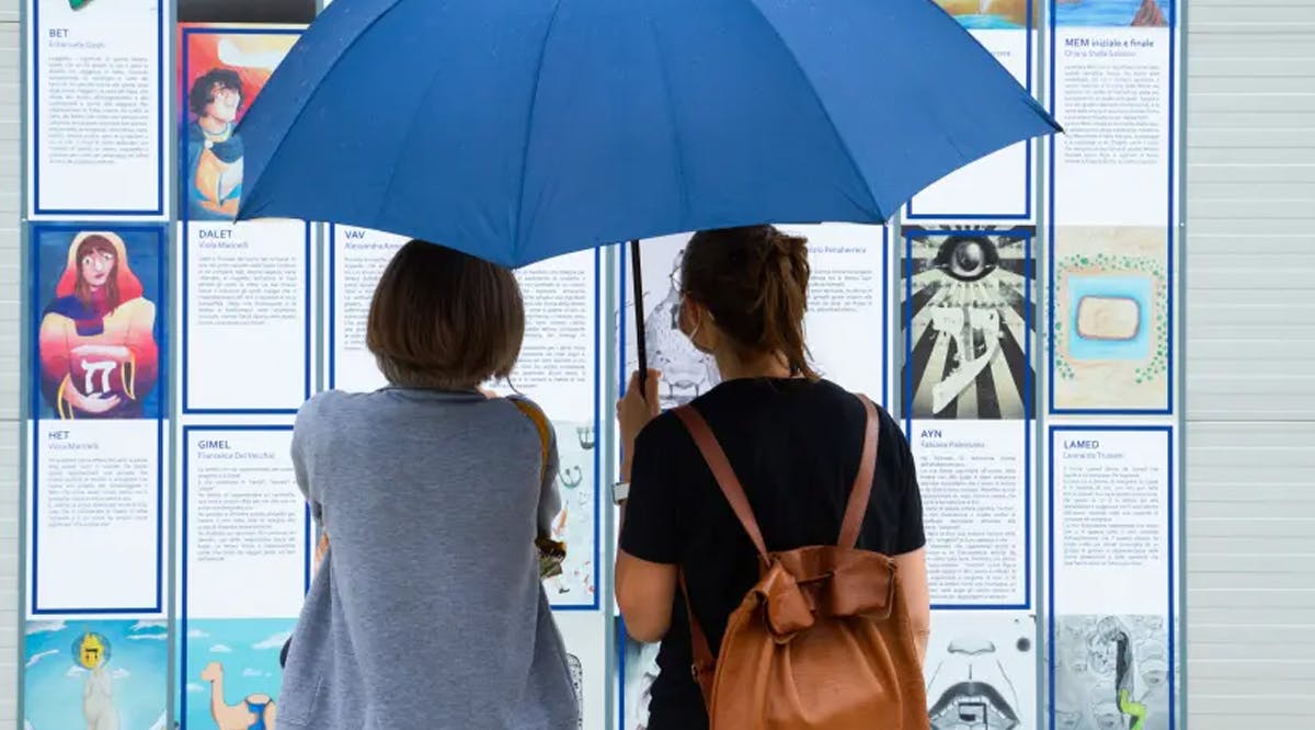 People looking at the exhibition “Designing Hebrew”