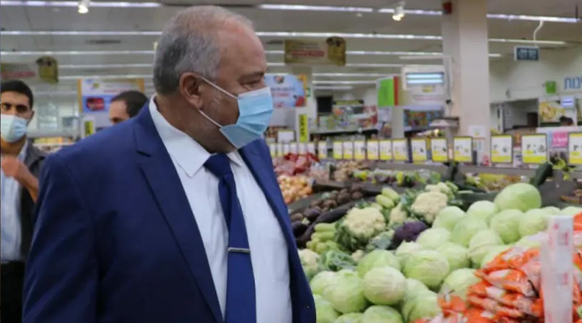 Finance Minister Avigdor Liberman checks food prices at a Jerusalem supermarket