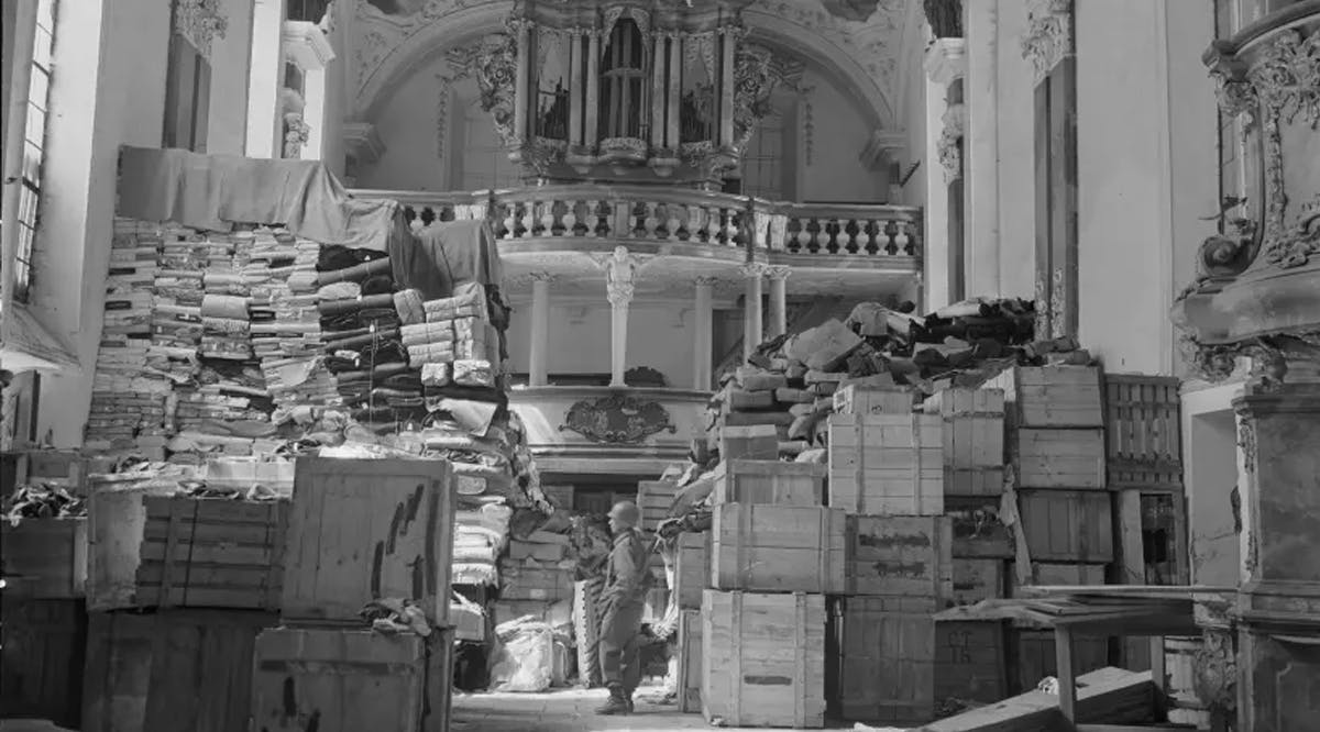 U.S. soldier viewing art stolen by the Nazi regime and stored in church at Ellingen, Germany
