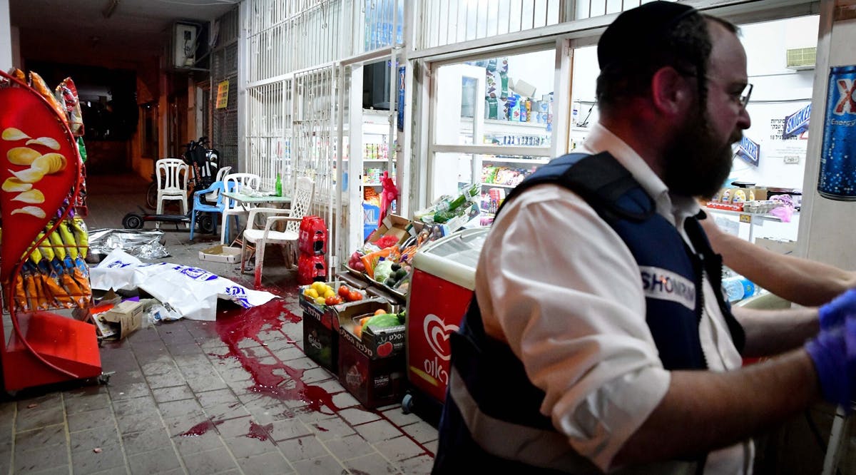 Israeli police officers and medics are seen at the scene of a terrorist shooting attack in Bnei Brak