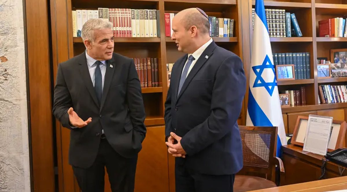 Outgoing Prime Minister Naftali Bennett and incoming Prime Minister Yair Lapid