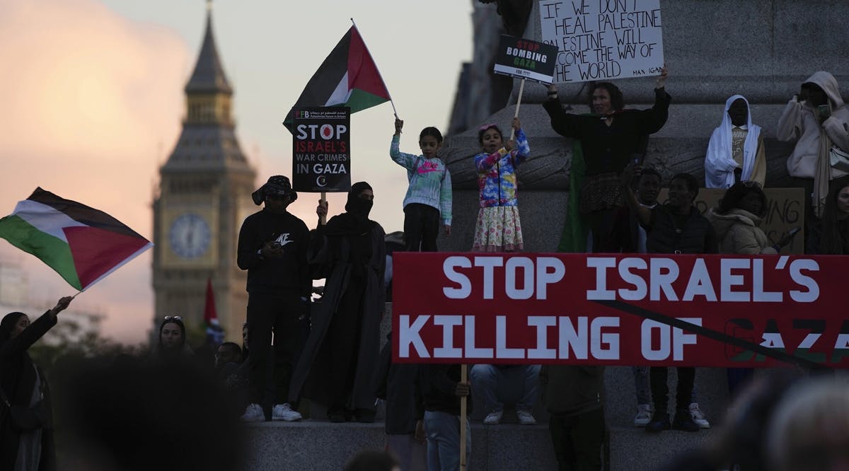 Protesters wave flags as they attend a pro Palestinian demonstration in London