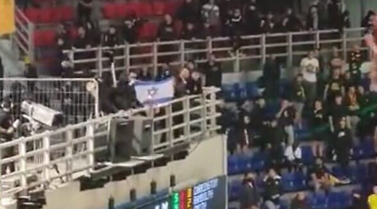 Fans of AEK Athens burn an Israeli flag at a match against Hapoel Jerusalem, in Athens, Greece