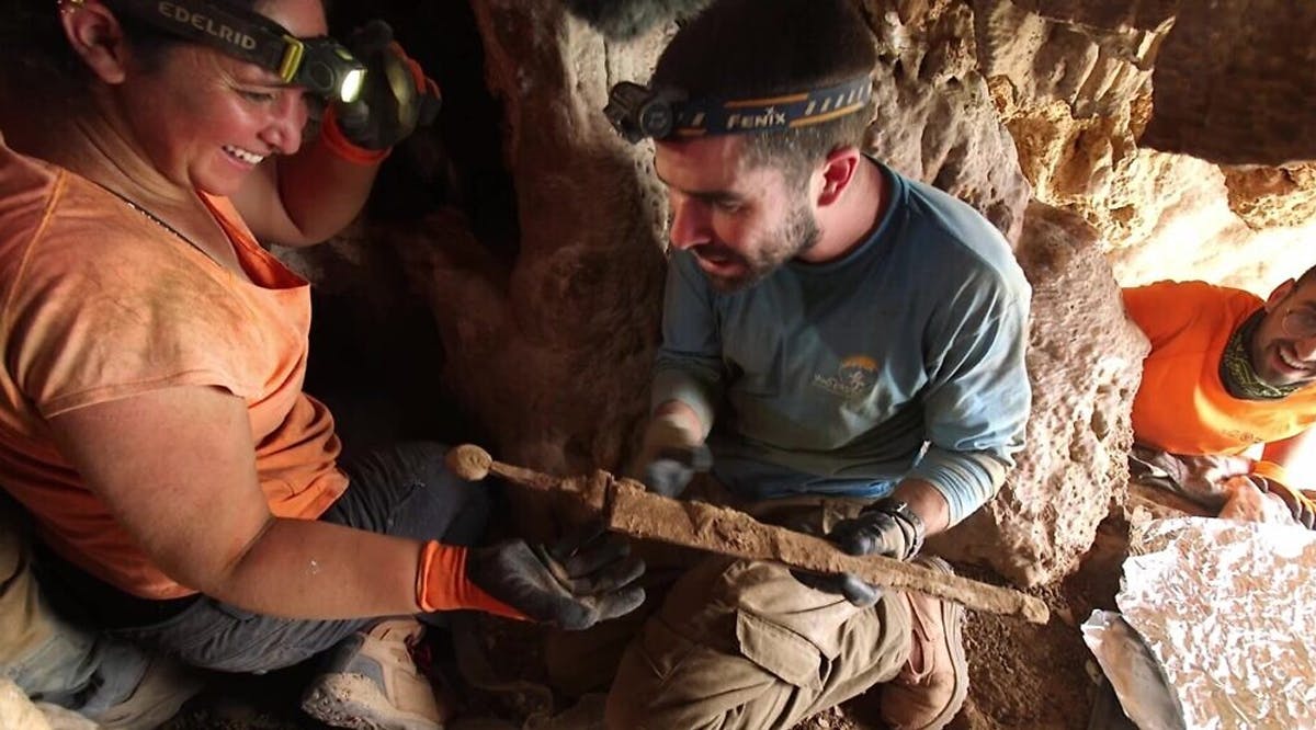 Archaeologists remove the swords from the rock crevice where they were hidden some 1,900 years ago in a cave in the Judean Desert