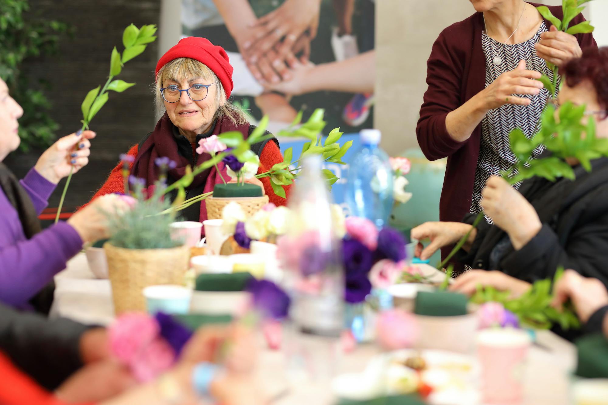 Holocaust survivors making flower bouquets 
