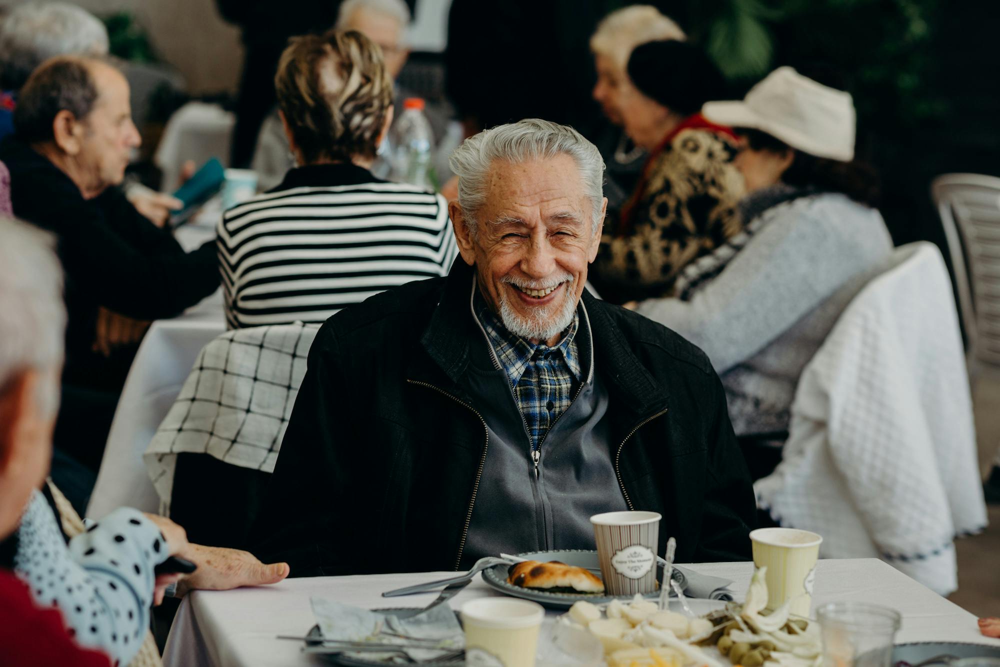 Holocaust survivor sitting and smiling