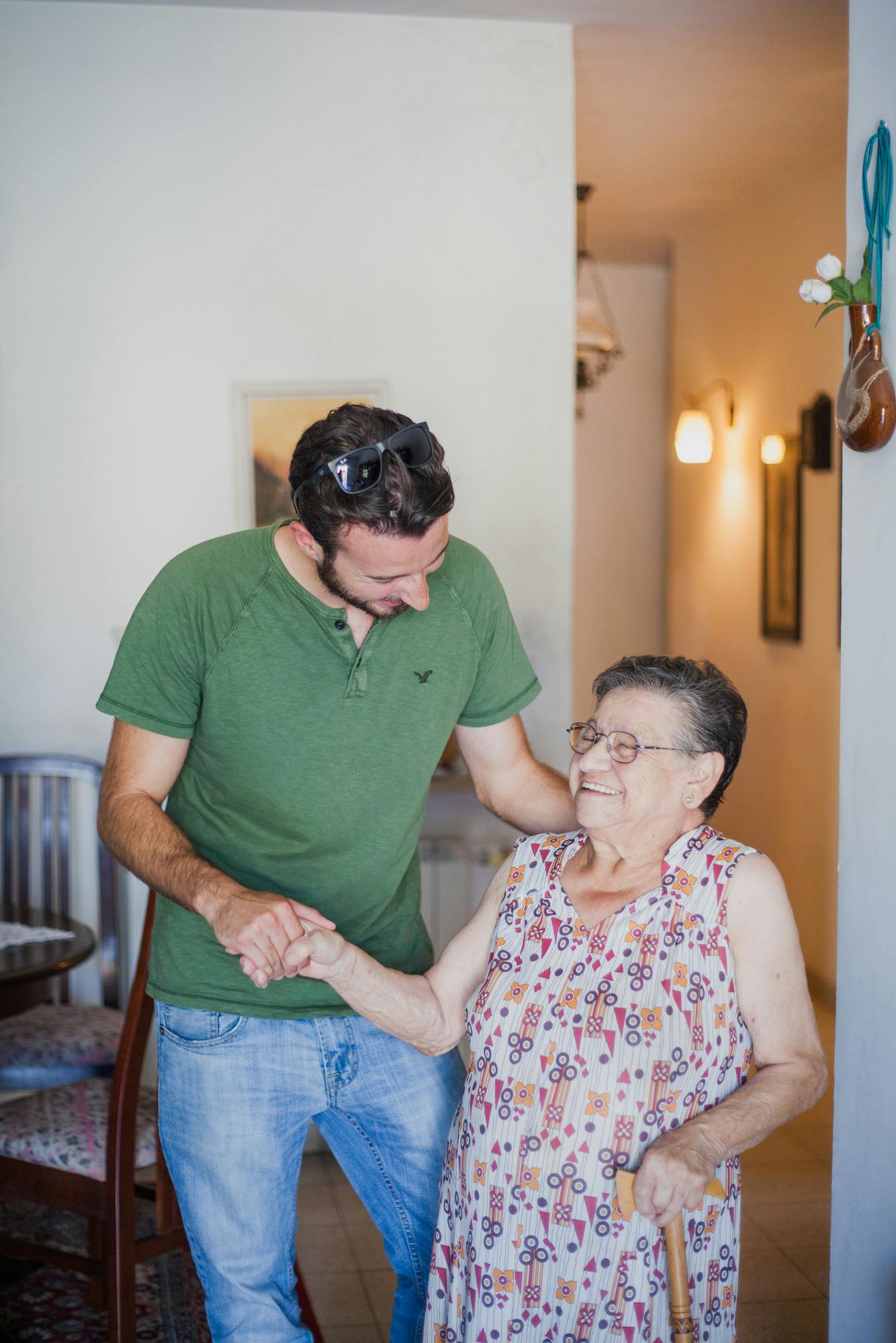 A man helping a elderly woman