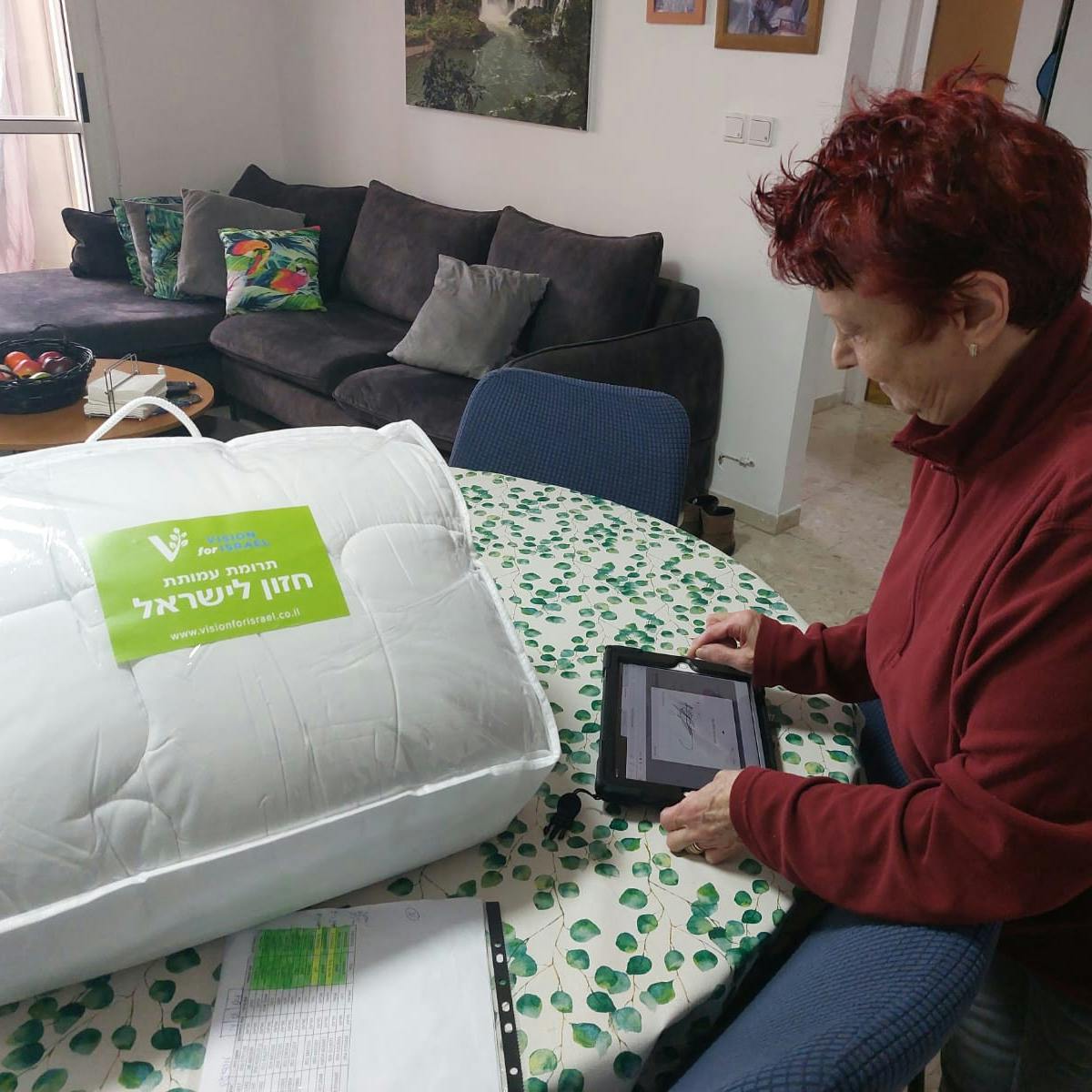 Elderly lady receiving a duvet