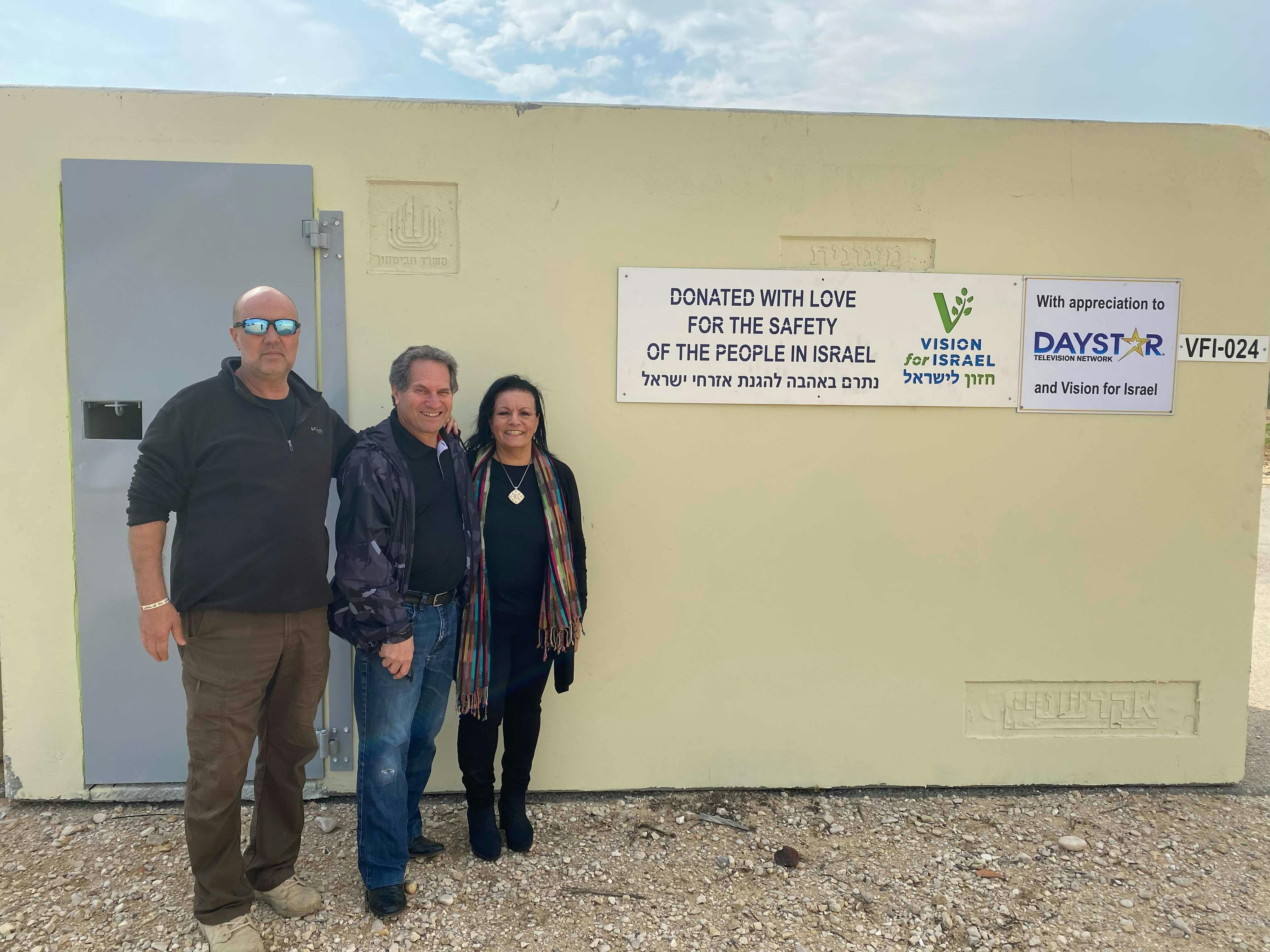 Barry & Batya standing next to a mobile shelter