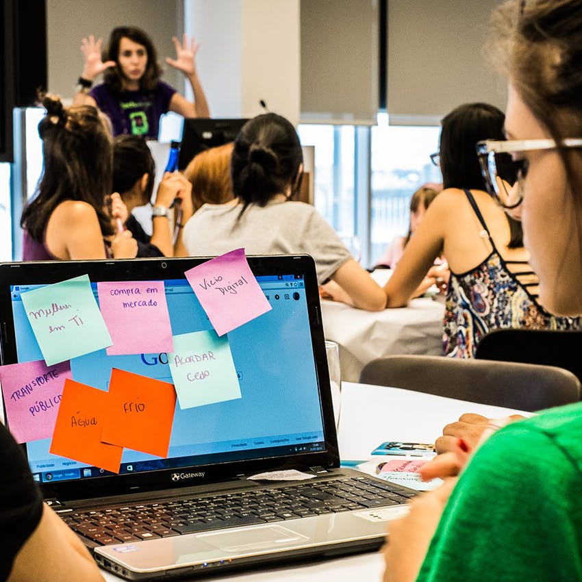 Camila (at the back) giving instructions during the 1st edition of the Technovation Challenge, a competition that stimulates girls to develop apps. São Paulo, SP, c. 2011.