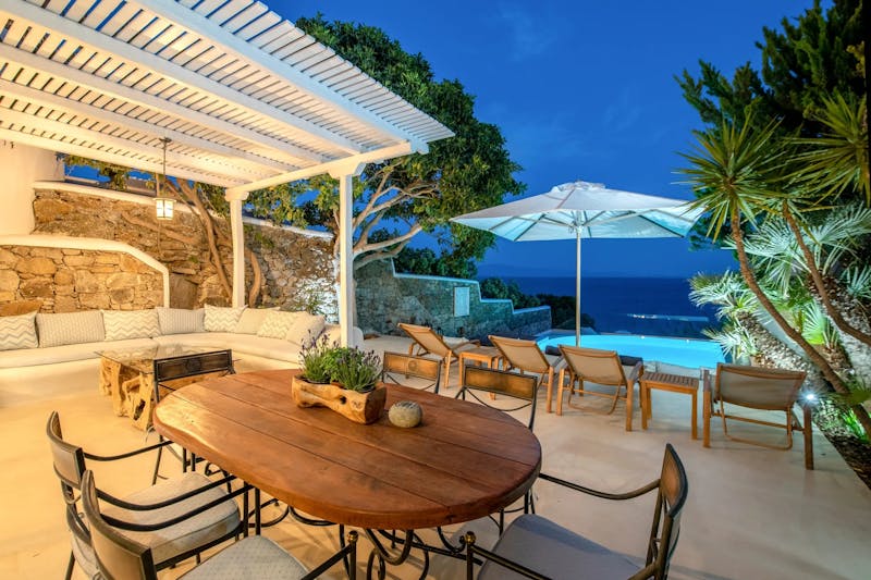 Outdoor Dinner area w pool & sea night views