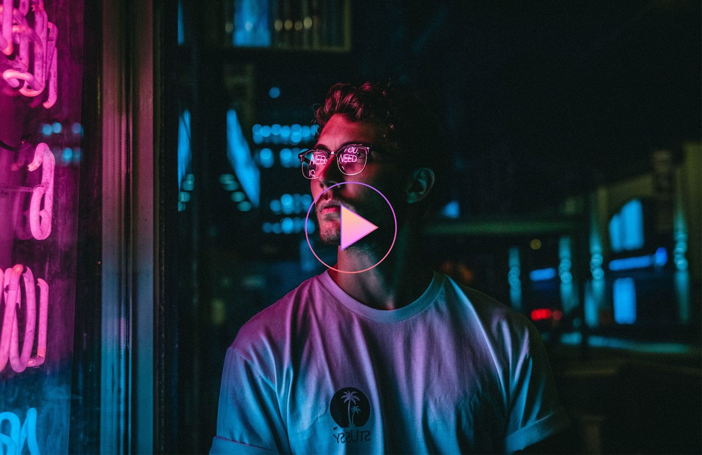 Man looking at glass storefront windowpane during night