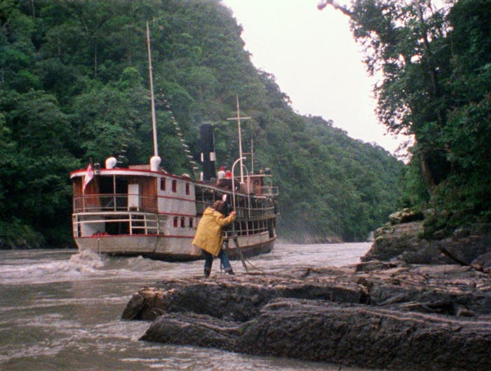 Boat on a river being filmed by camerman