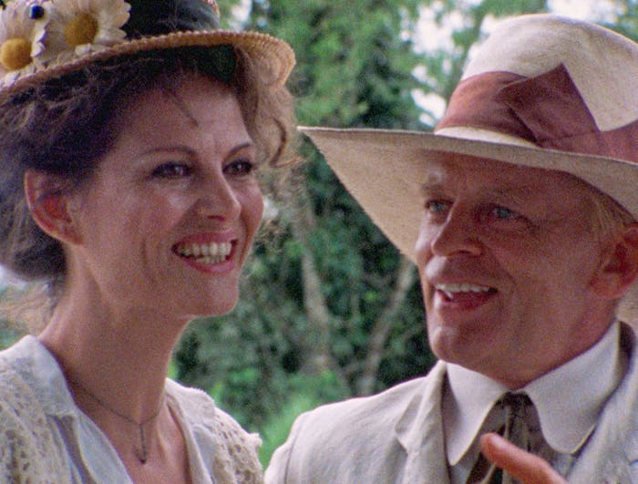 A man and a woman stand together laughing