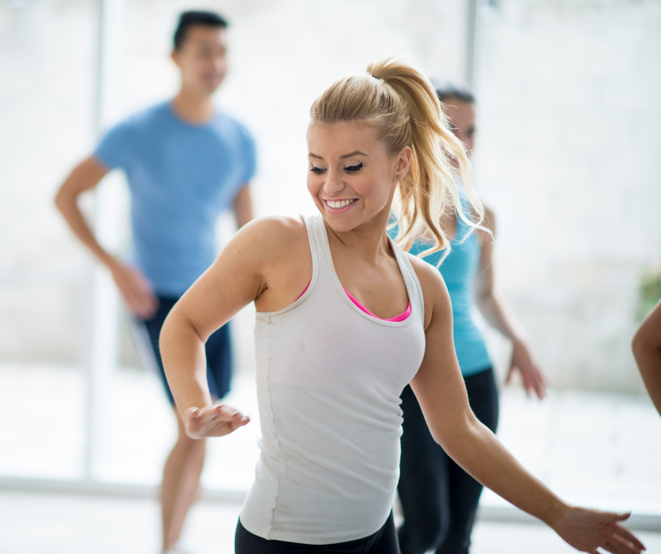 Image of a woman smiling in a gym class