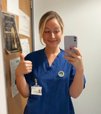 Jess taking a selfie in her nurse's uniform