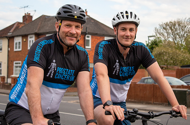 Father and son together smiling on their bikes