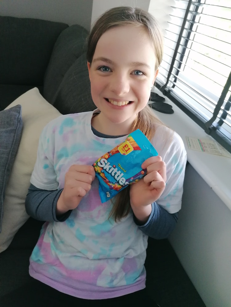 Little girl holding a bag of sweets