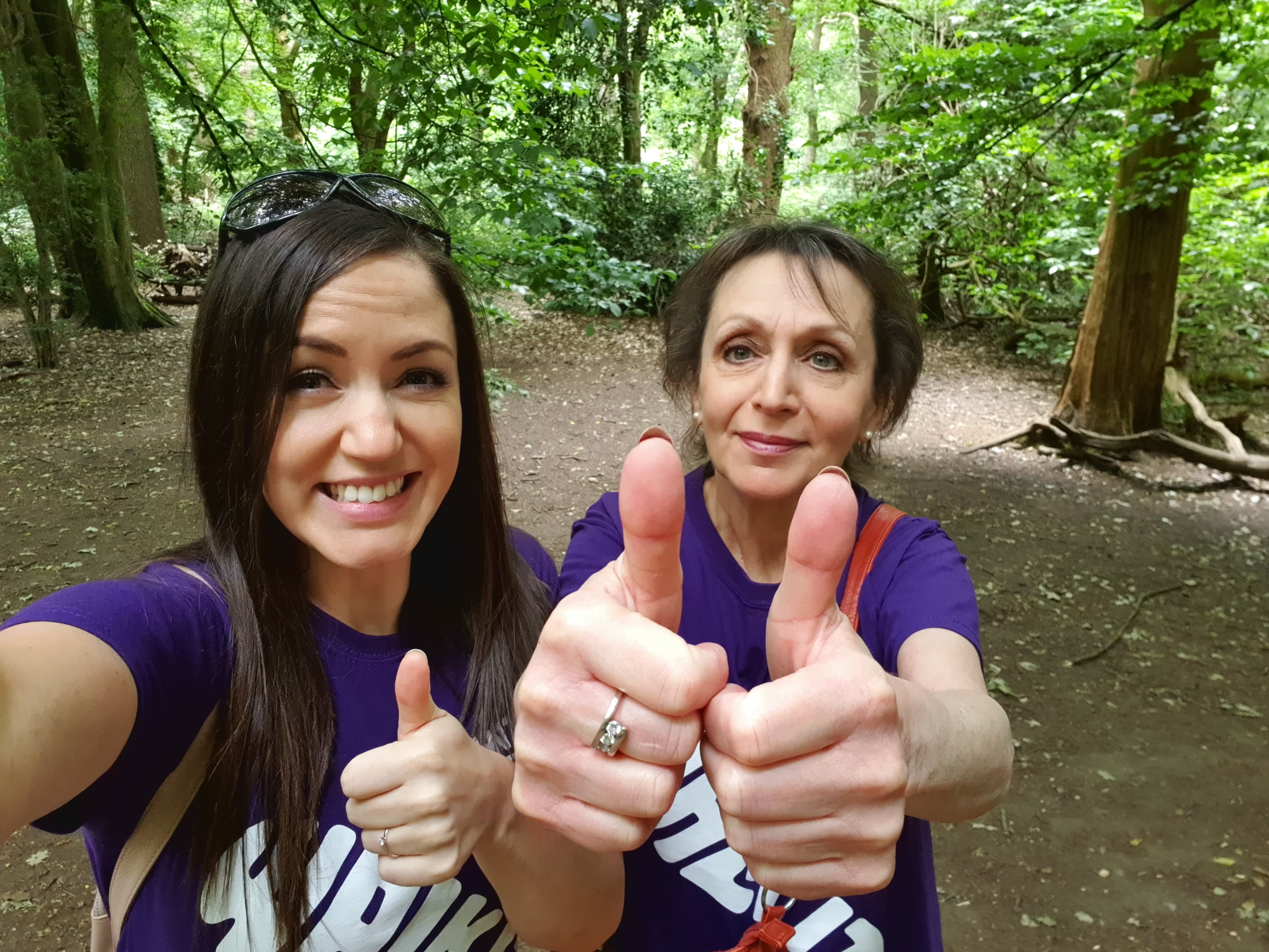 Two women doing thumbs up.