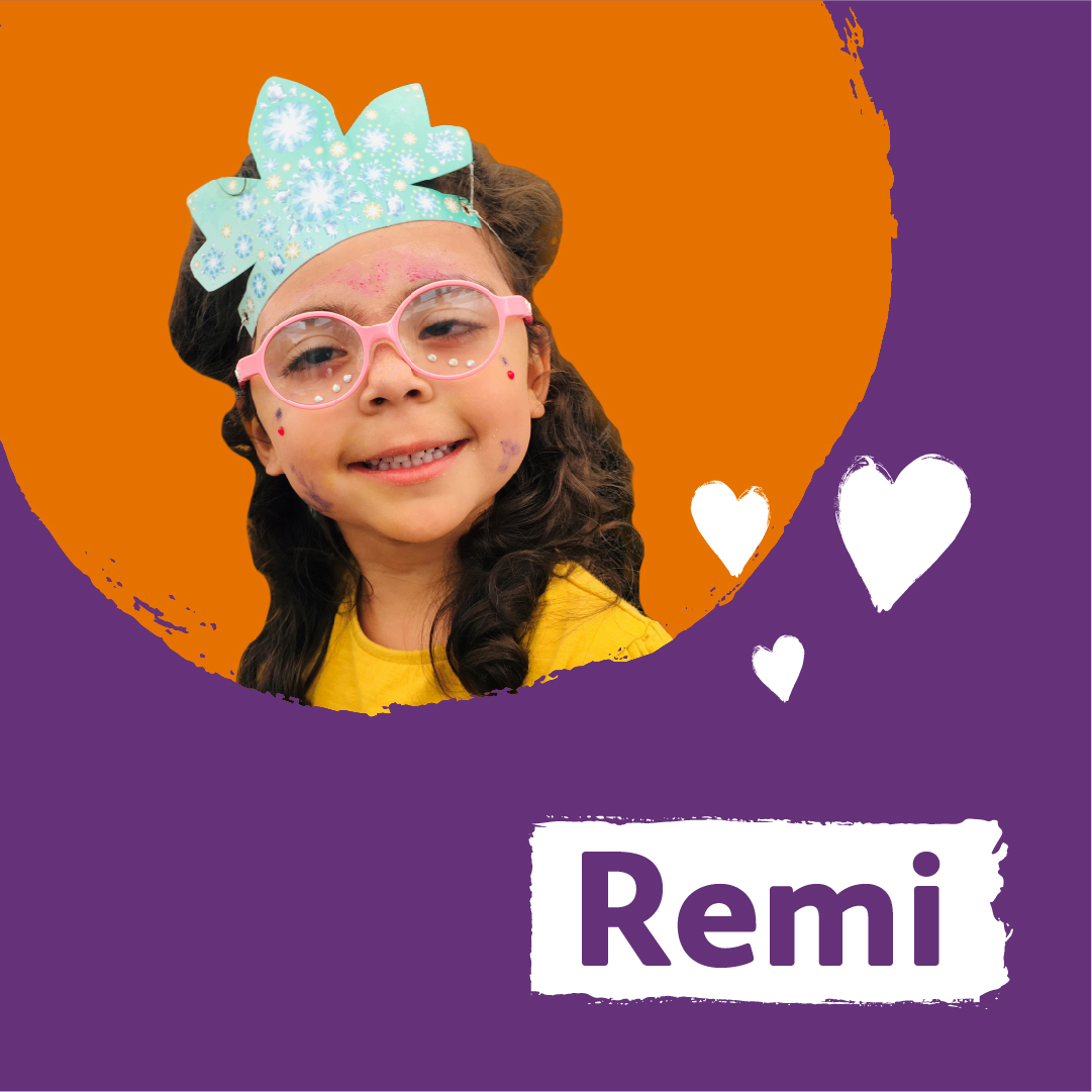 Remi - A girl wearing pink glasses and a blue party hat is smiling. The name Remi is written underneath her