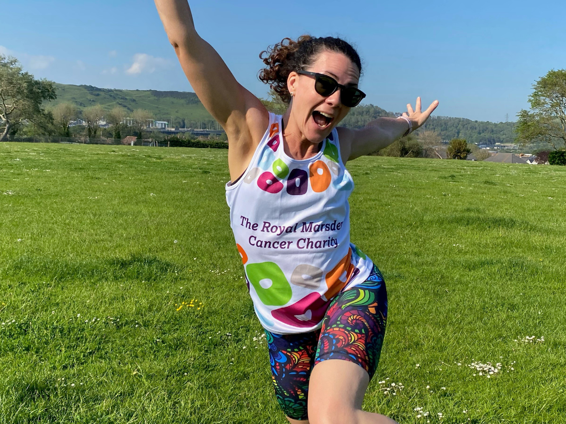 Woman leaping in shorts and t-shirt in a park