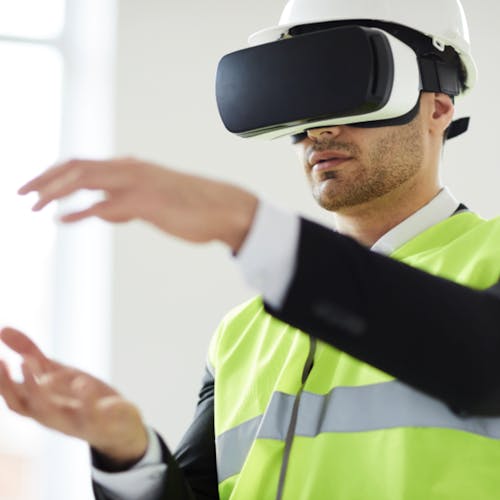 Man in a hi-vis jacket wearing virtual reality goggles
