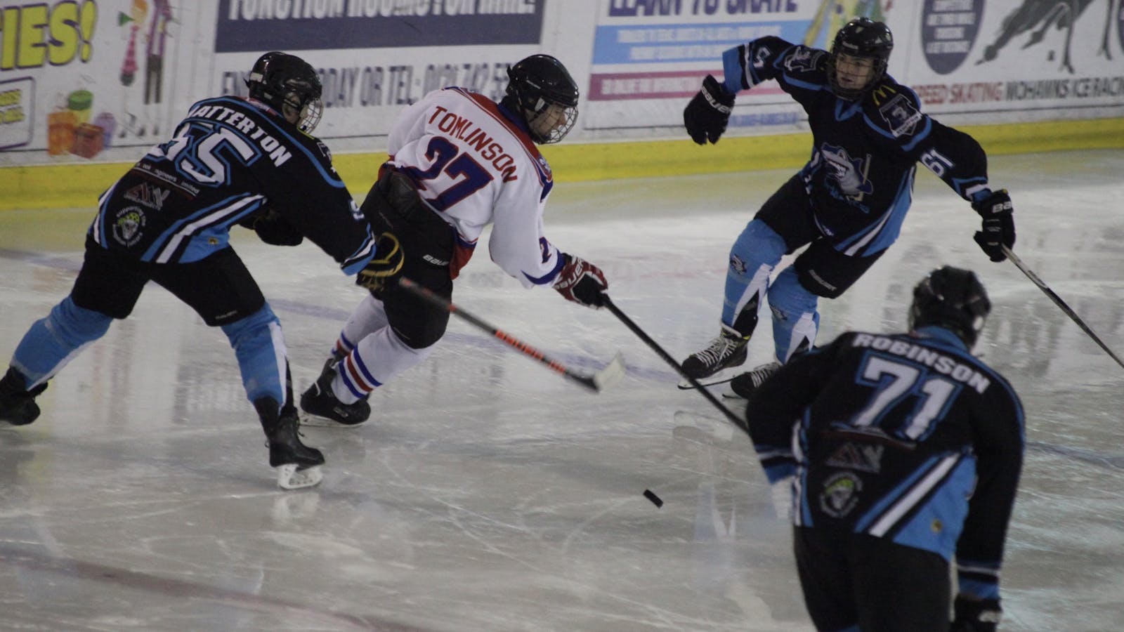 James Tomlinson playing ice hockey