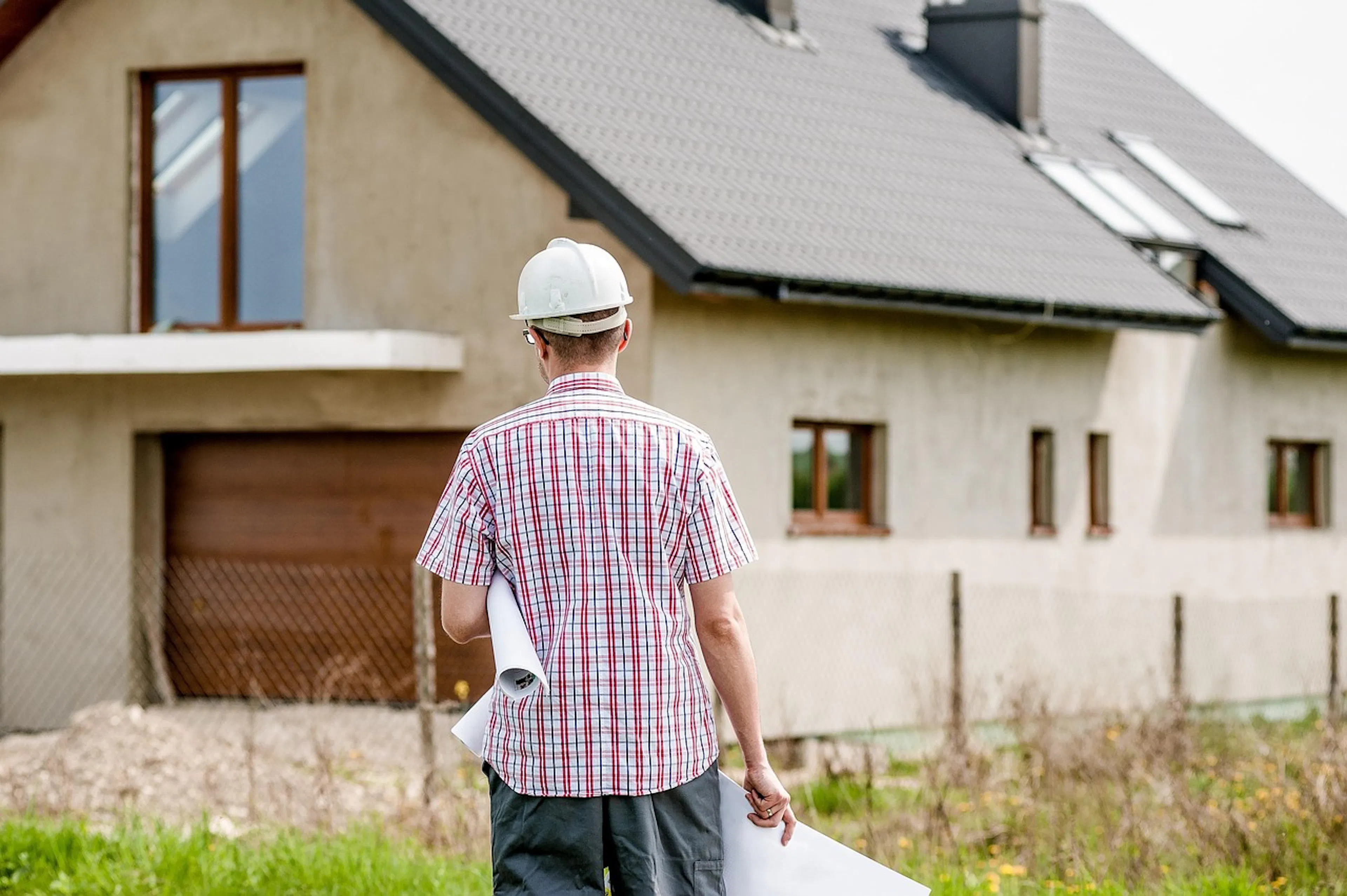 Man walking with a house plan