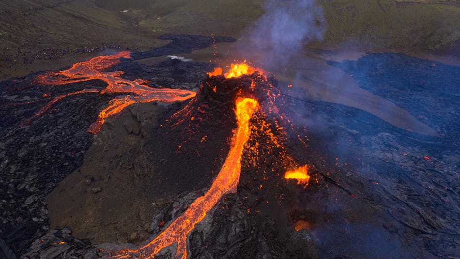 Red hot lava rivers flowing from a volcanic crater