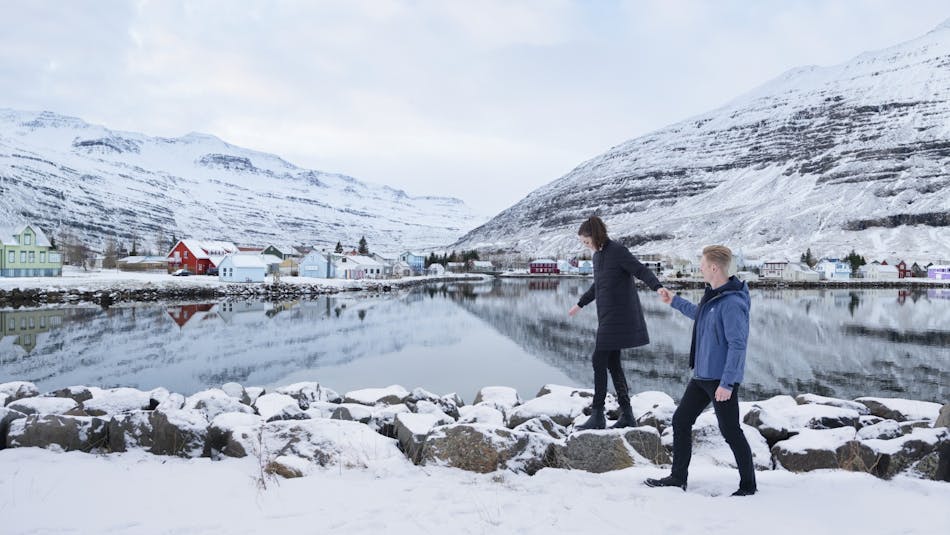 People walking in snow in Seydisfjordur town