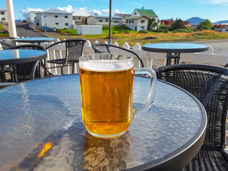 A beer glass on a table outside