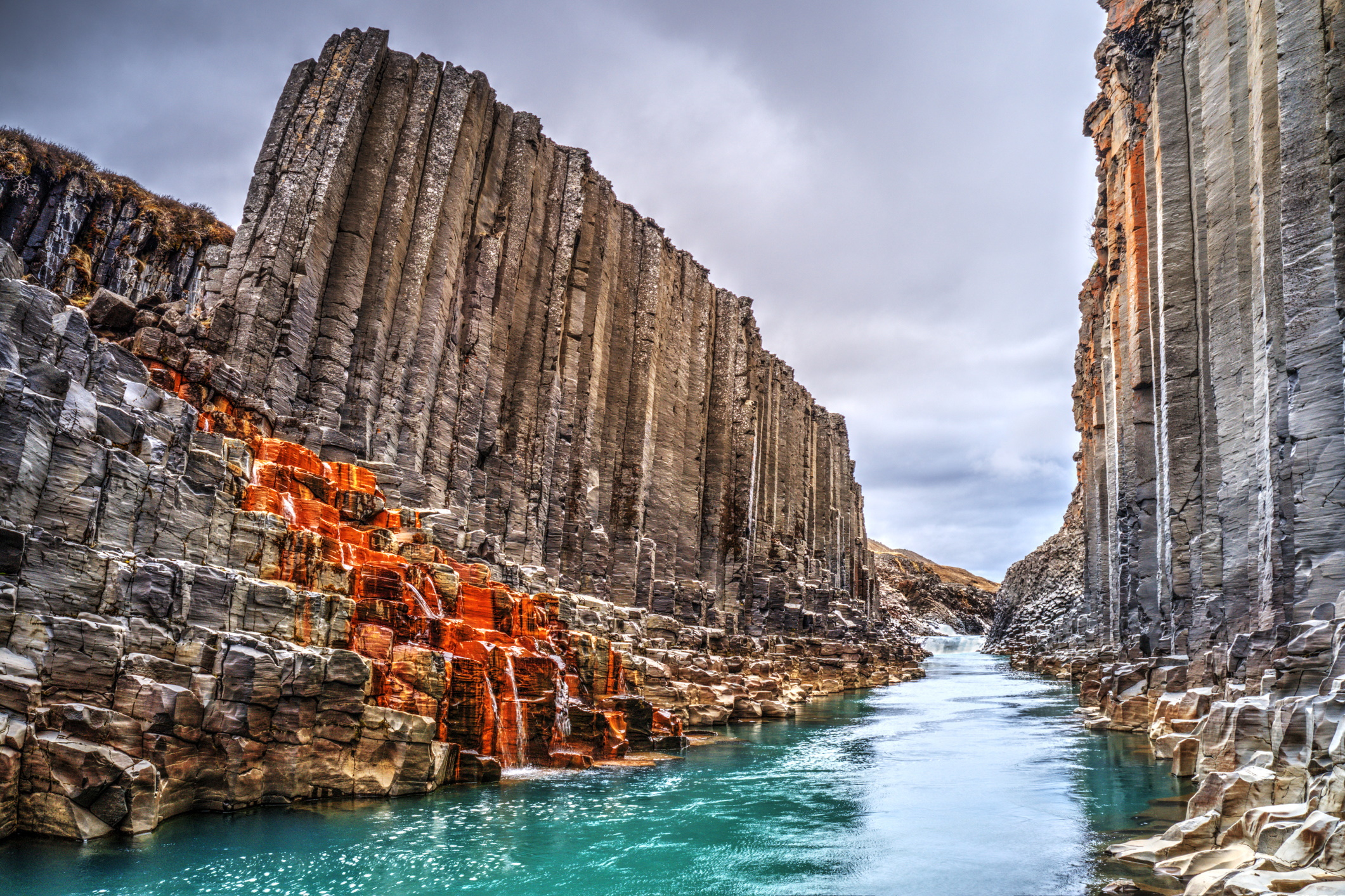 Blue river canyon with columnar rock walls