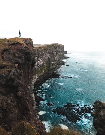 A man standing on a seacliff