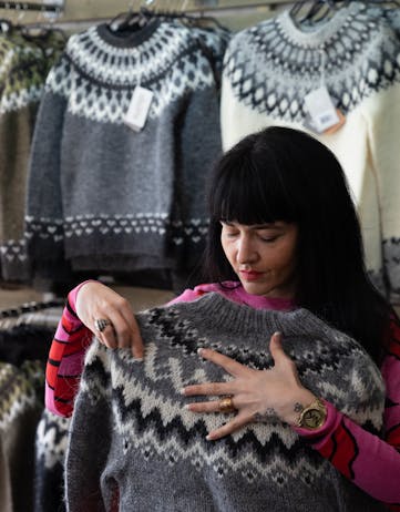 woman folding a lopapeysa