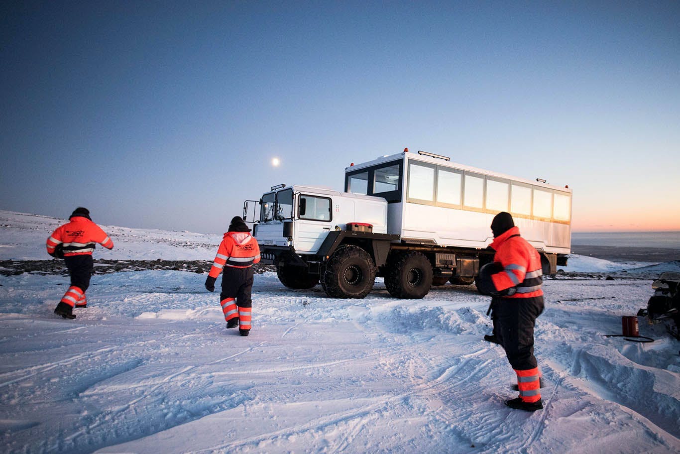 On monster trucks exploring Icelandic glacier