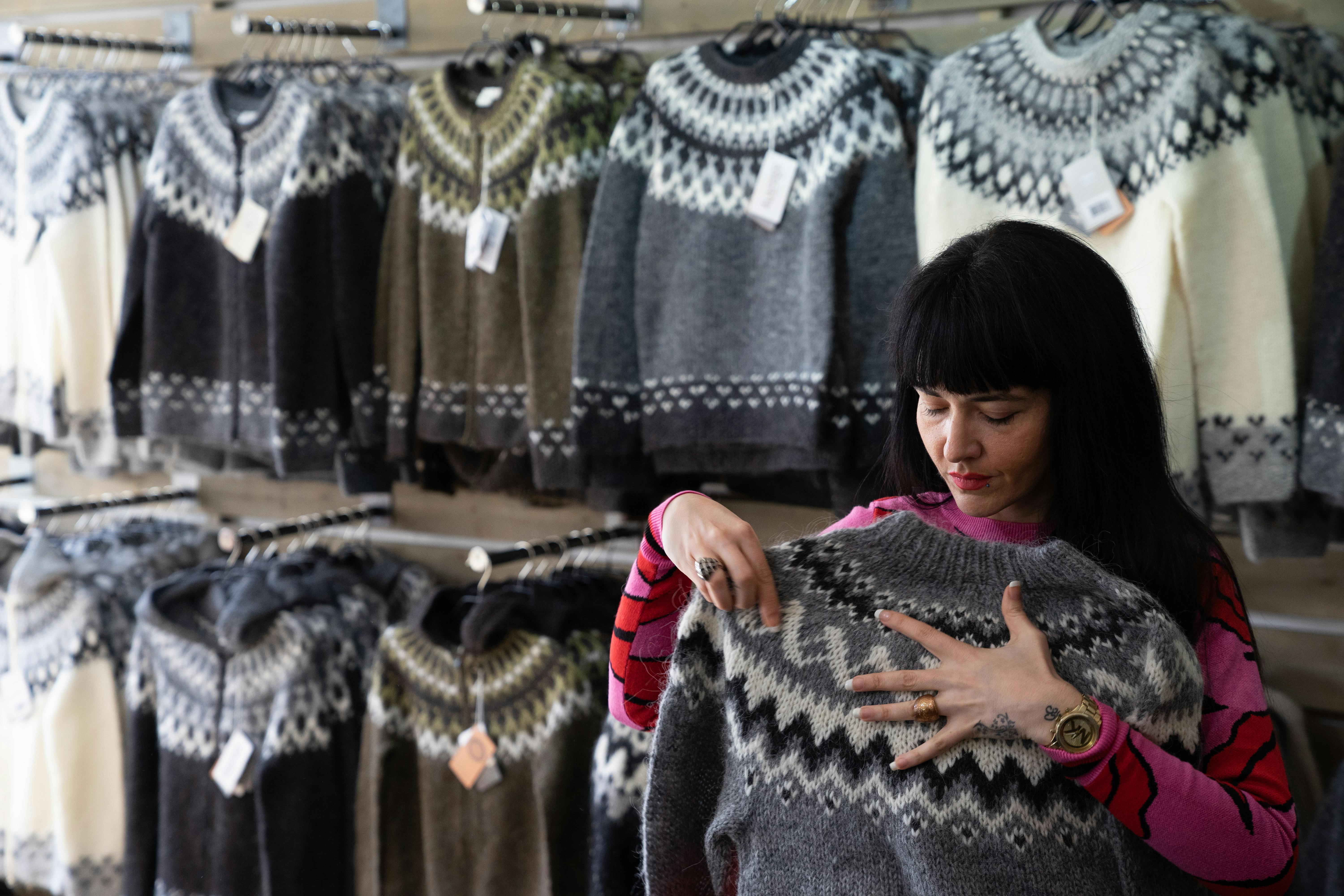 Woman in a shop that sells Icelandic sweaters, also called lopapeysur