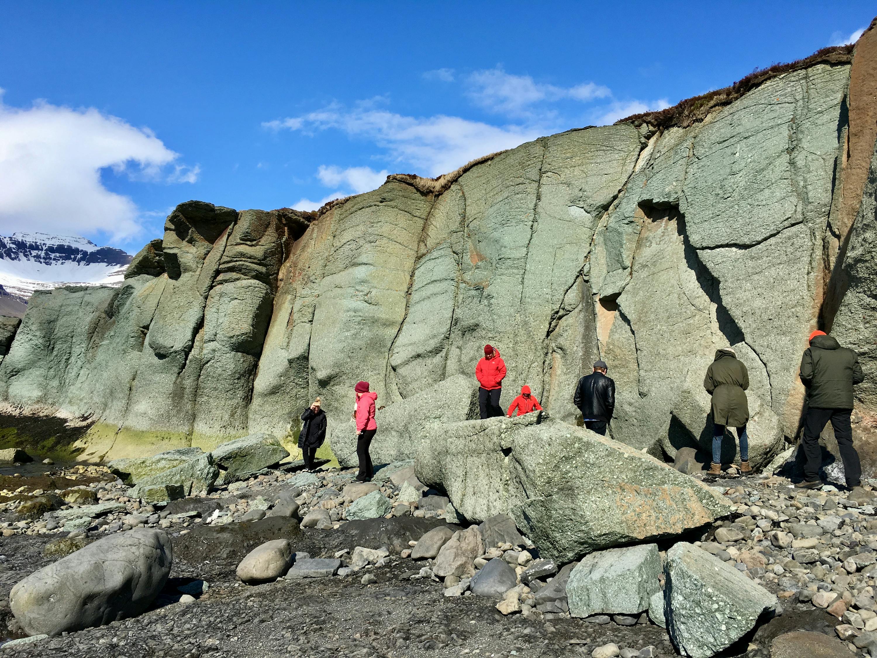 A few people exploring a blue cliff
