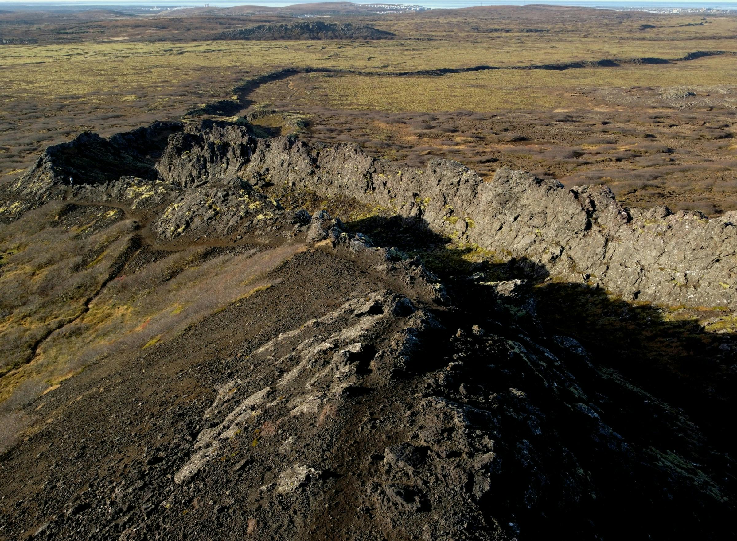A channel in a lava field leading from a crater